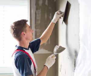 Sheffield plasterer applying plaster to interior wall