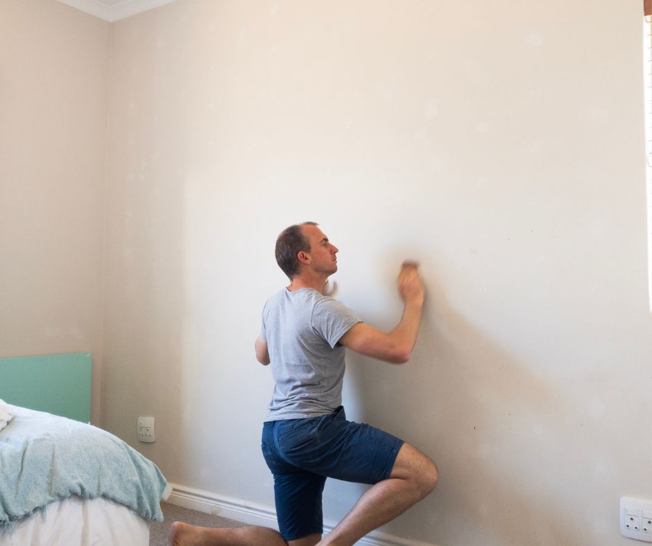 Sanding the filled plaster patch.