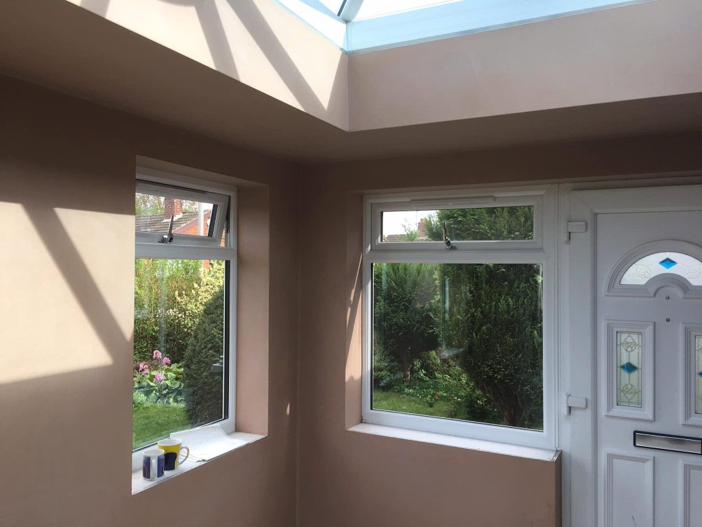 Smooth newly plastered walls around conservatory windows by P3 Plastering