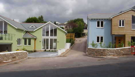Properties with green and blue coloured exterior render finishes