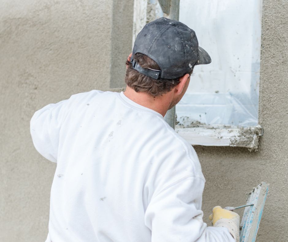 Tradesperson applying render to an exterior wall