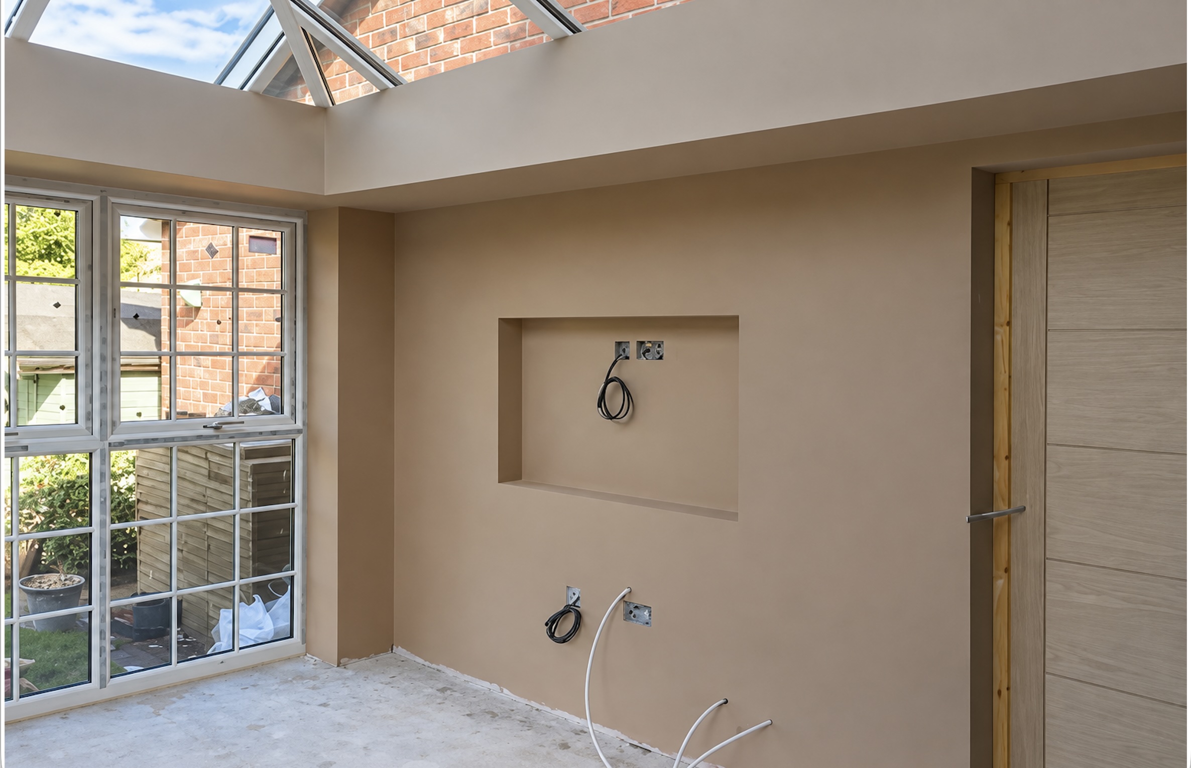 Plastered stud wall with recessed TV opening and concealed services by P3 Plastering