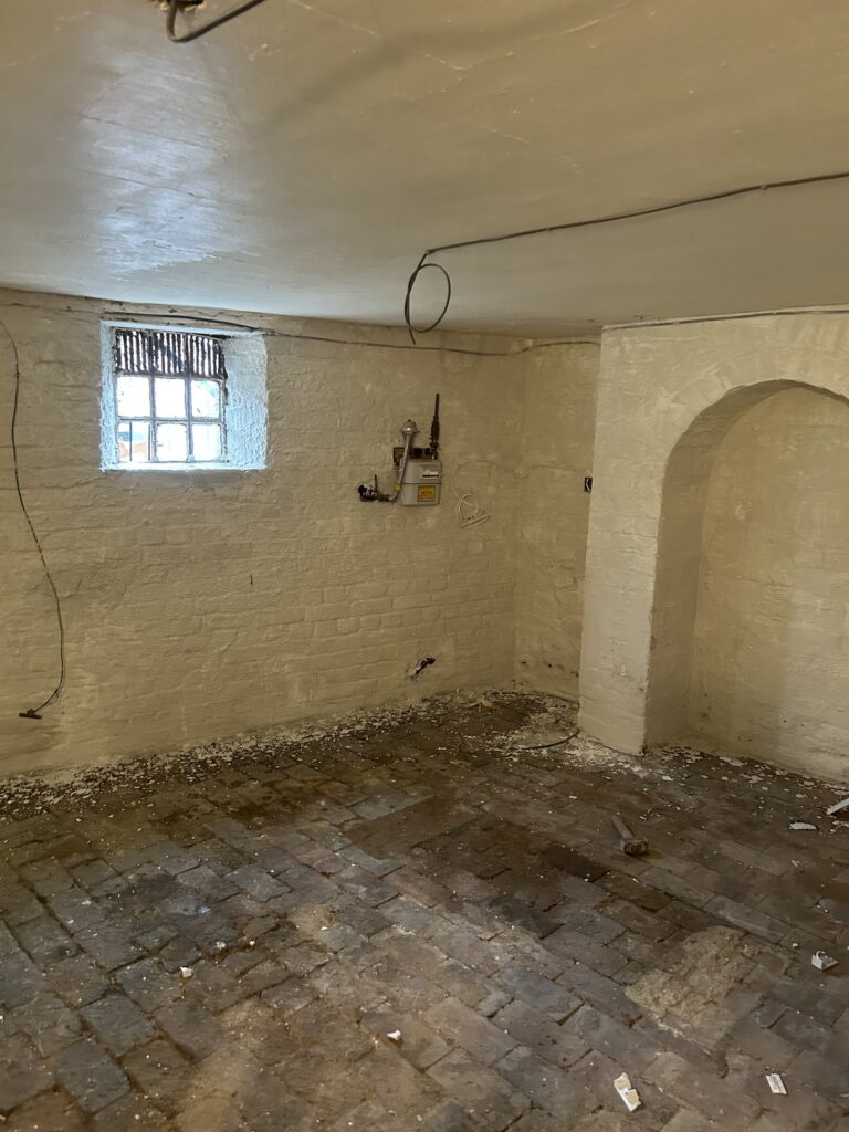 Brick basement walls coated with a specialist treatment during a P3 Plastering project.